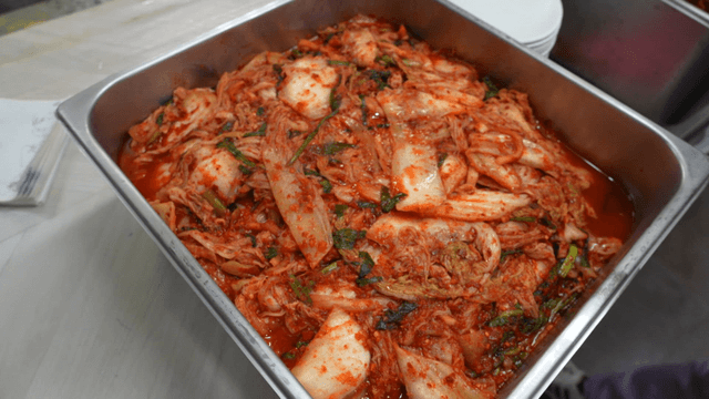 Kimchi in metal container in kitchen