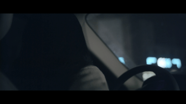 Woman driving at night in the city