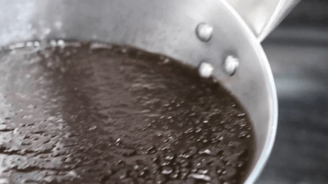 Broth with slushy ice scooped with a ladle
