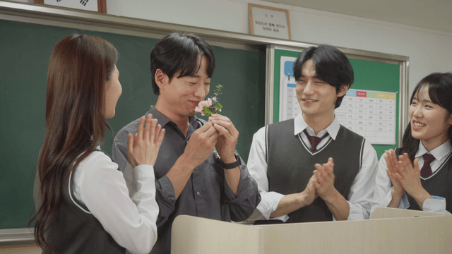 Students giving flowers to their teacher on Teacher’s Day