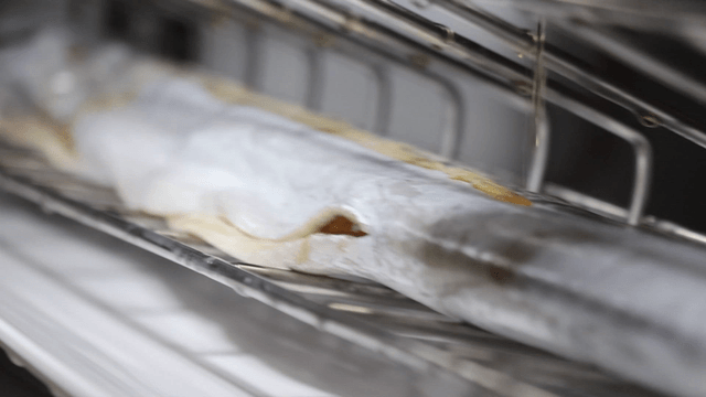 Sesame oil poured over cutlassfish on an oven tray
