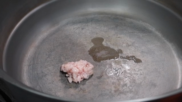Adding ingredients to a pot for cooking