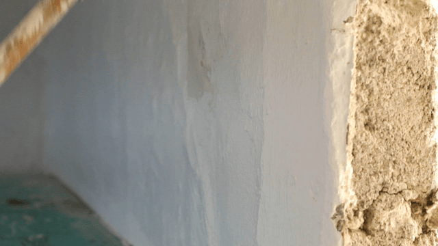 Painting a wall with a roller brush