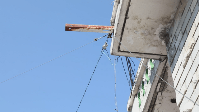 Old building facade with rusty metal bar