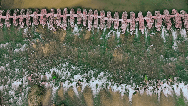 Overhead view of a stone bridge over a river