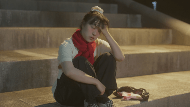 Girl sitting on the stairs at night feeling hot