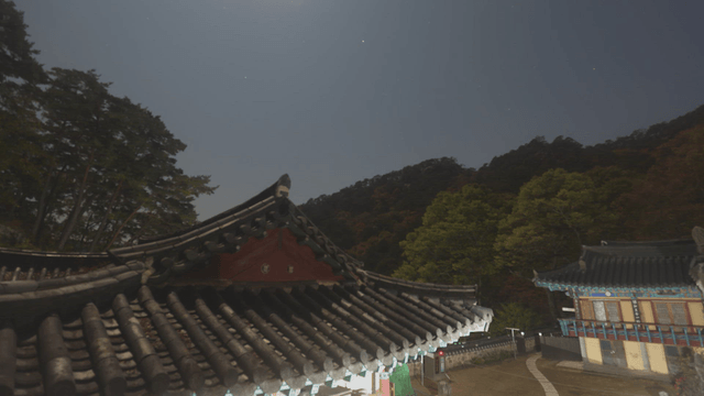 Sky above a temple shifting from night to dawn