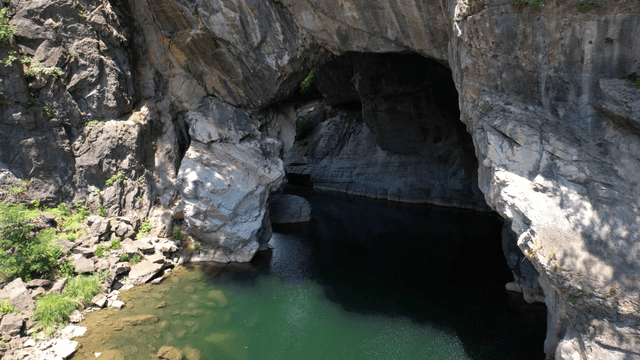 Clear river flowing through quiet cave