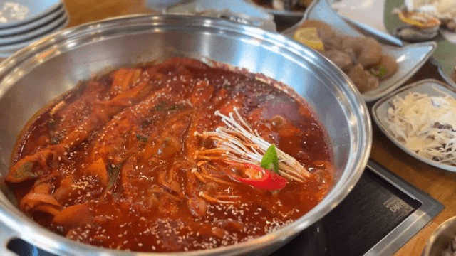 Spicy cutlassfish stew boiling in a serving pot