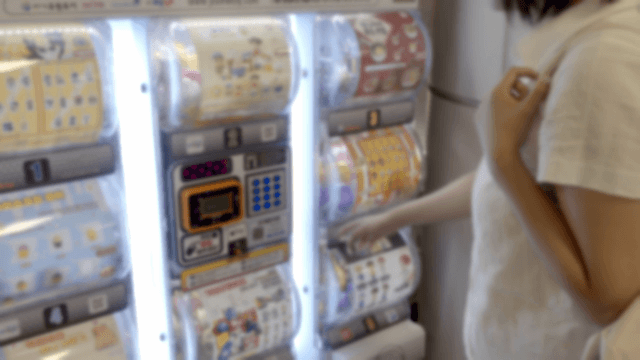Person looking at gacha machines in a shop