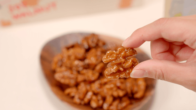 Bowl of glazed walnuts on a table