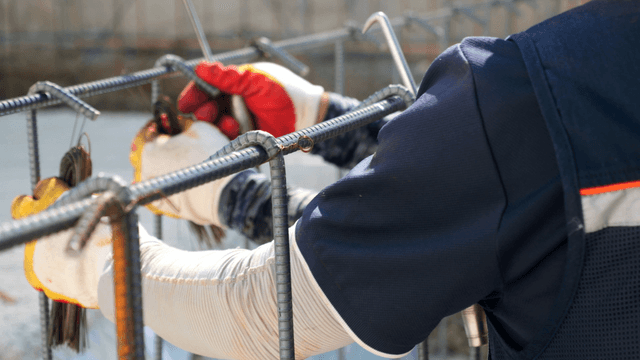 Worker tying rebar at a construction site