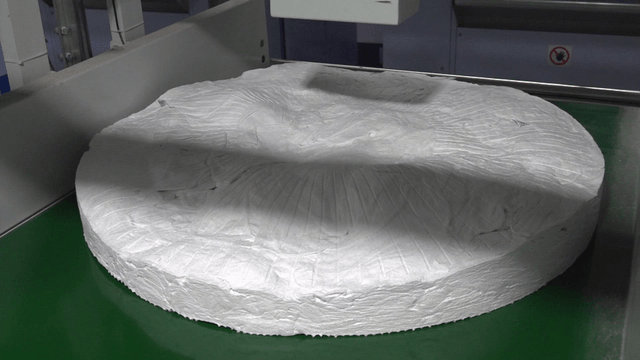 Large white disc on a conveyor belt