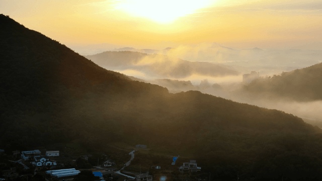Sunrise over a rural village and fields