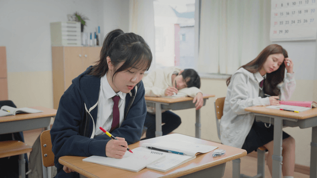 Teacher waking a sleepy student and answering questions during self-study time