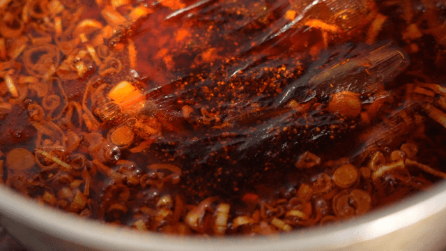 Teabag simmering in scallion and chili oil