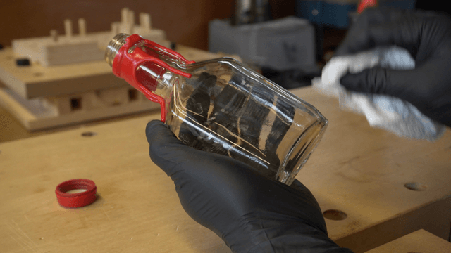 Cleaning a glass bottle with a cloth