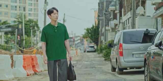 A man walking down a street under construction