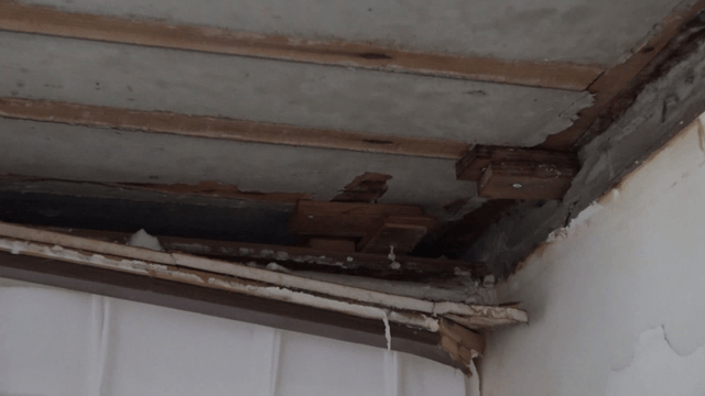 Exposed ceiling wood and insulation from aging
