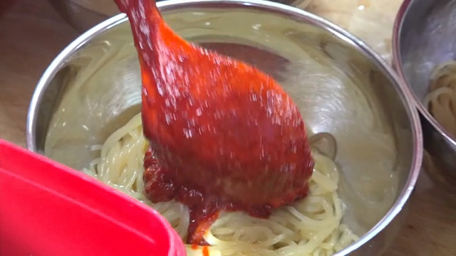 Spicy sauce placed on top of chewy noodles