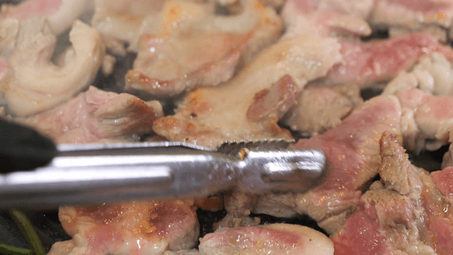 Grilling pork on a hot pan