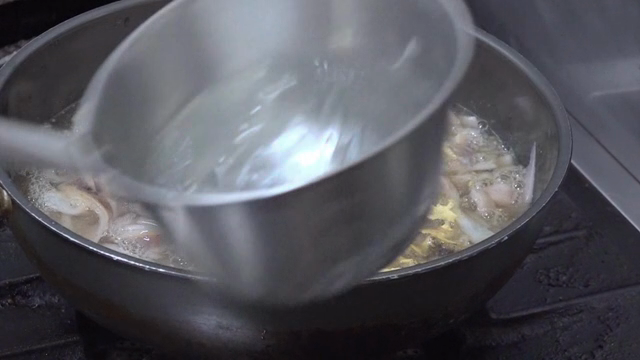 Squid being boiled in a pot with water