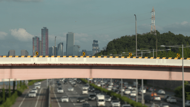 Busy highway with distant city skyscrapers
