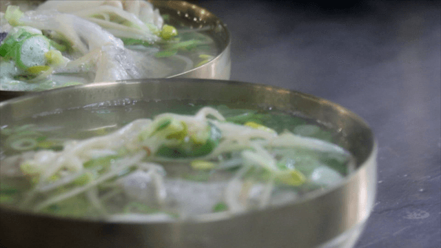Steaming cod soup in brass bowls