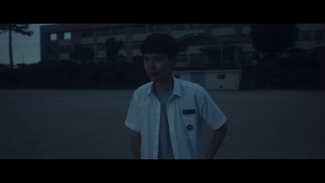 Student crying sadly in schoolyard at dark night