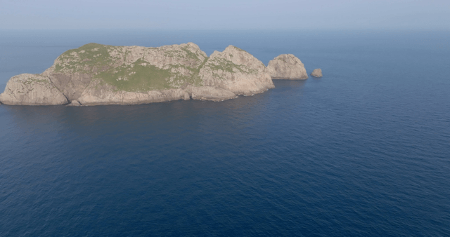 A distant view of a rocky island