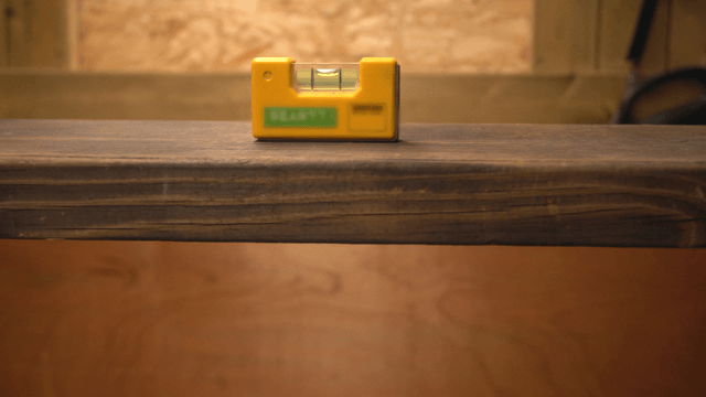 Handcrafted wooden bench with a level placed on top