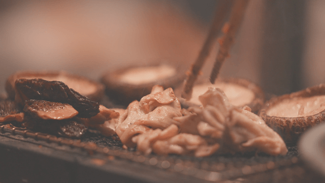 Various mushrooms grilling on barbecue
