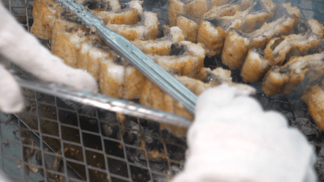 Eels flipped over charcoal fire