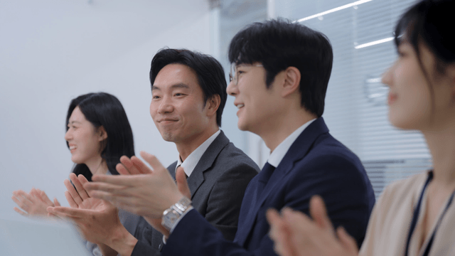 Business meeting with colleagues clapping