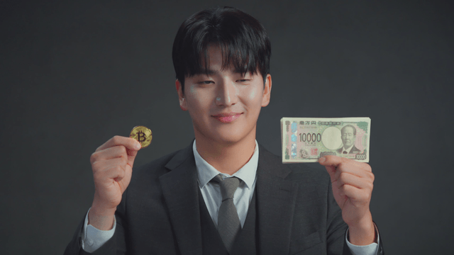 Man smiling at the Bitcoin in his hand