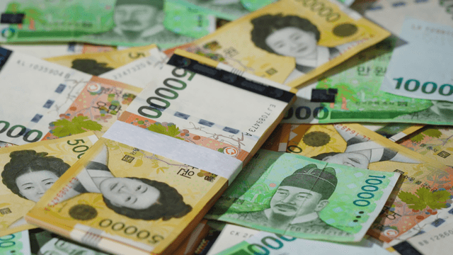 Various Korean banknotes scattered