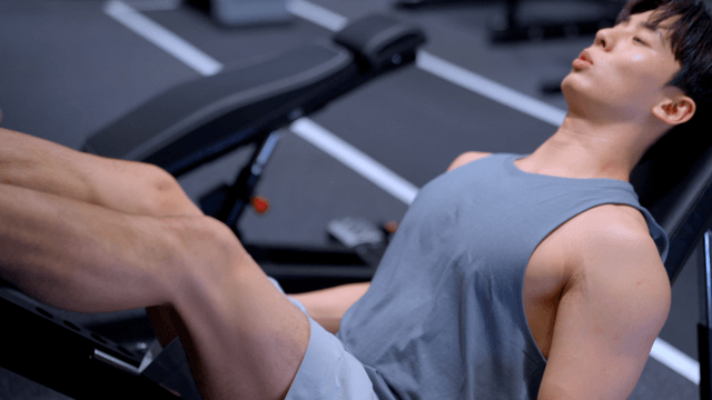 Man exercising on a leg press machine