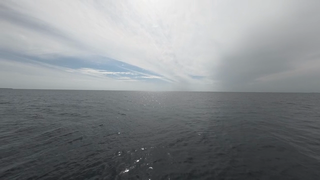 Calm ocean under a cloudy sky