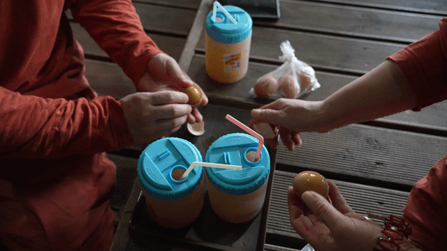People peeling roasted eggs and drinking sikhye in a jjimjilbang