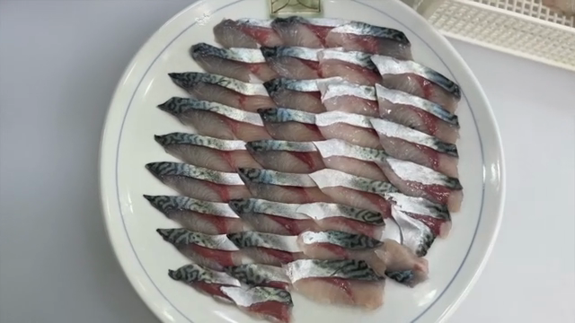 Sliced mackerel arranged on a plate