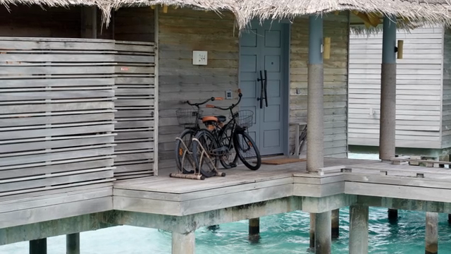 Bicycles parked on a wooden deck by the water