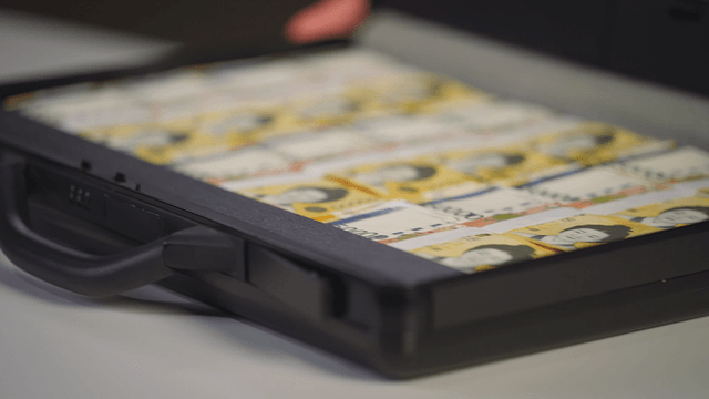 A briefcase filled with stacks of cash