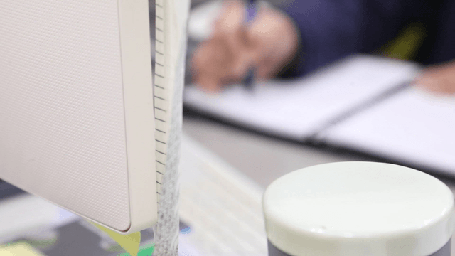 Person writing notes at a desk