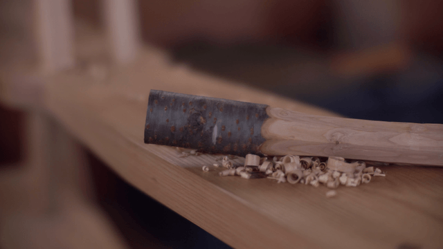 Wooden handle on a workbench with shavings