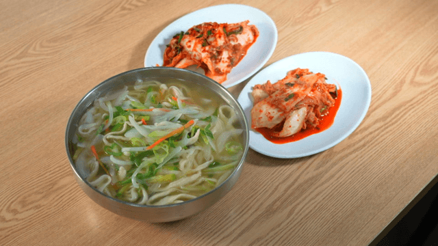 Hand-cut noodle soup served with kimchi side dishes