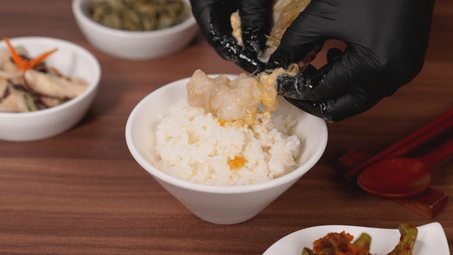 Rice with marinated crab being prepared