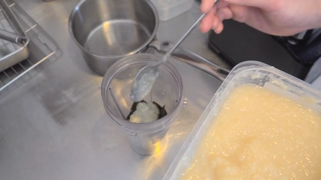 Spoonful of rice koji salt being added to a blender