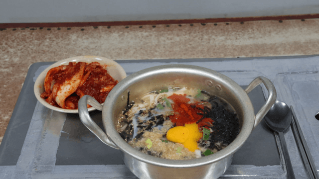 Kimchi and chicken noodle soup with egg on the table