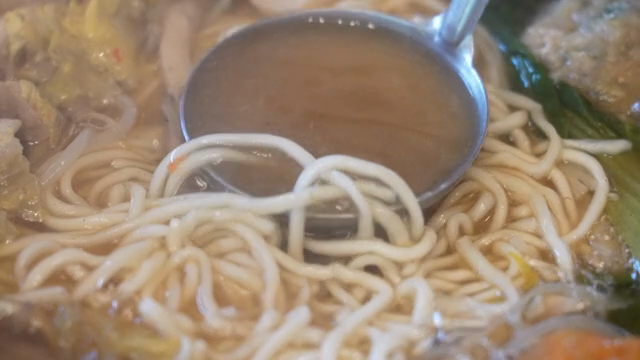 Broth from Korean hot pot with noodles and vegetables