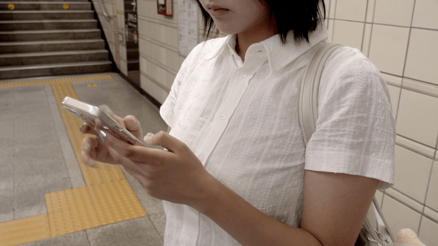 Woman using a smartphone in a subway station
